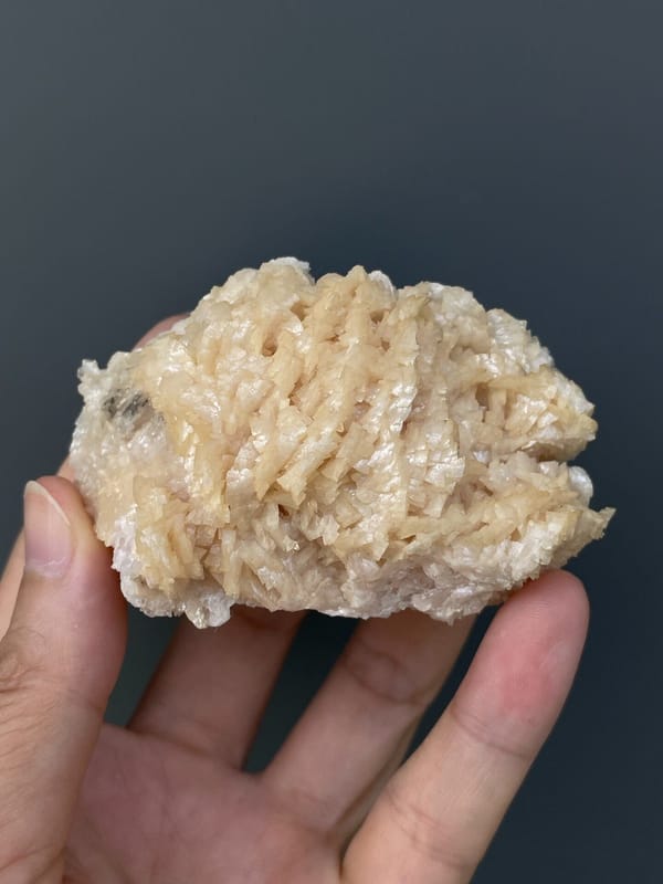 Cream-white dolomite crystal mass from Hunan, China, held in hand