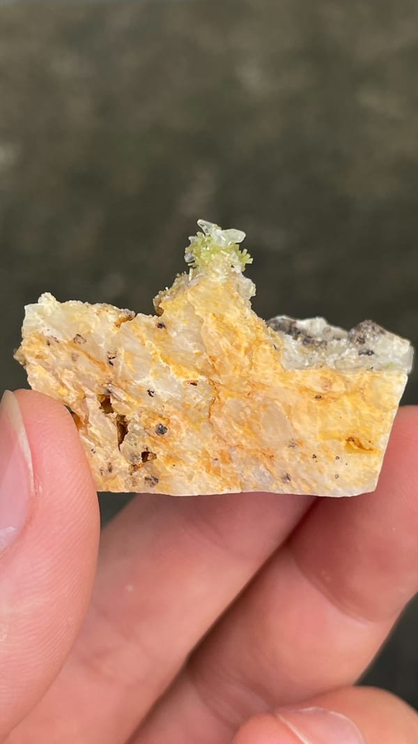 Pale cerussite plate with a tuft of green pyromorphite from Guangdong, China, close-up of the crystal faces