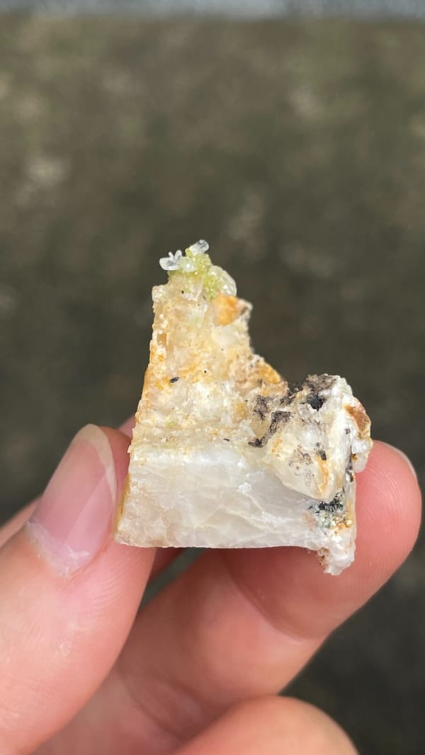 Pale cerussite plate with a tuft of green pyromorphite from Guangdong, China, reverse side