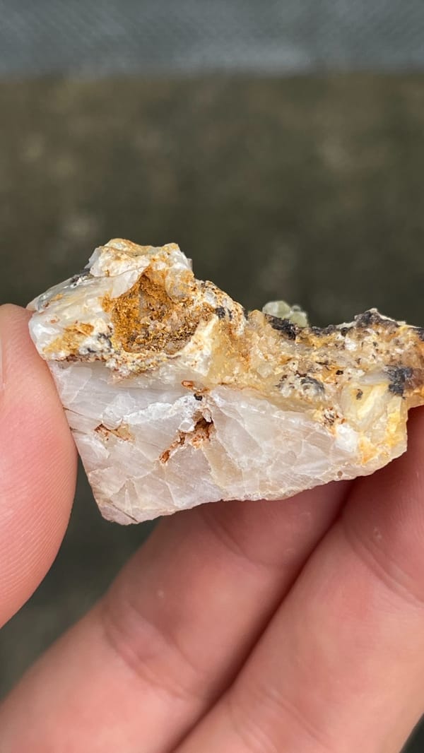 Pale cerussite plate with a tuft of green pyromorphite from Guangdong, China, top view