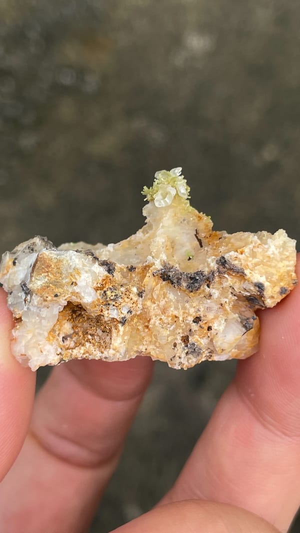Pale cerussite plate with a tuft of green pyromorphite from Guangdong, China, detail of the matrix contact