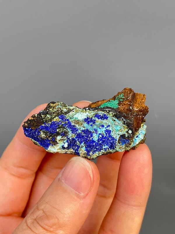 Electric blue azurite with green staining and pale gibbsite, Yunnan, China, detail of the matrix contact