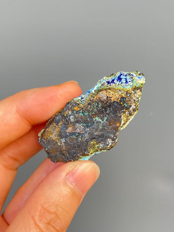 Electric blue azurite with green staining and pale gibbsite, Yunnan, China, side view