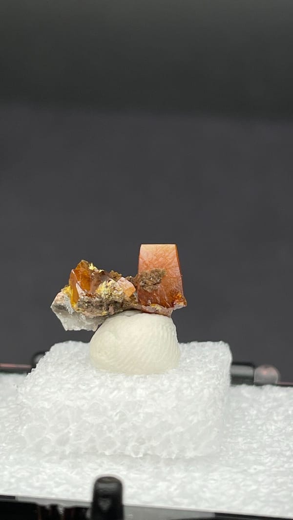 Orange tabular wulfenite with green mottramite from Ojuela Mine, Durango, Mexico, detail of the matrix contact