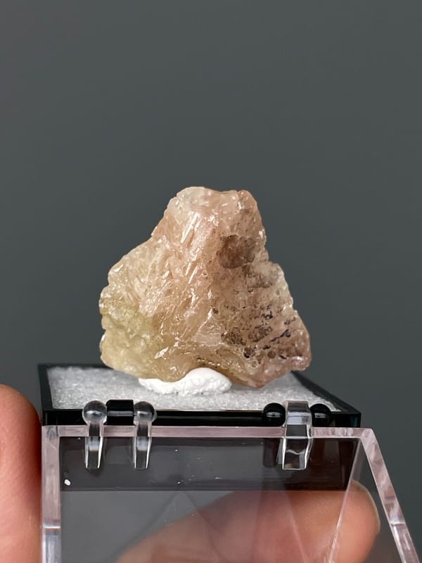 Translucent pale peach cerussite crystal from Gongcheng, Guangxi, China, detail of the matrix contact