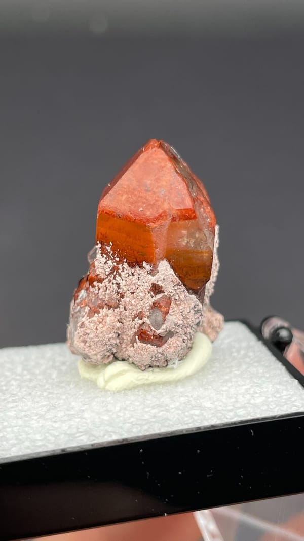 Deep red hematoid quartz crystal with frosted base from Shanxi, China, in a box, close-up of the crystal faces