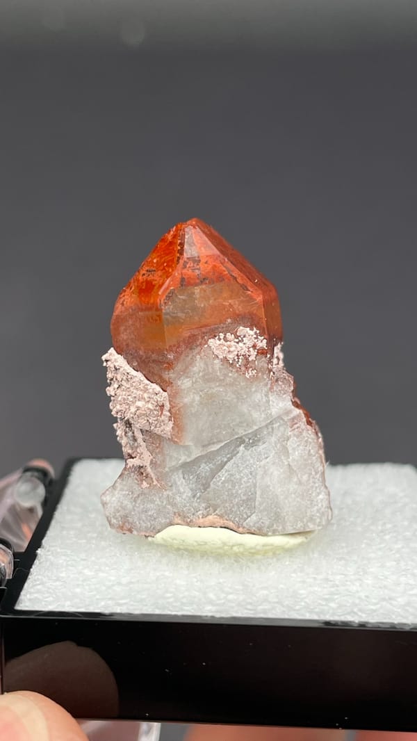 Deep red hematoid quartz crystal with frosted base from Shanxi, China, in a box, top view
