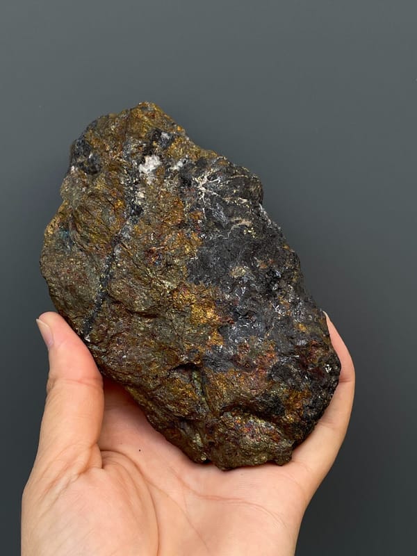 Large iridescent bronze and violet chalcopyrite mass from Hubei, China, close-up of the crystal faces