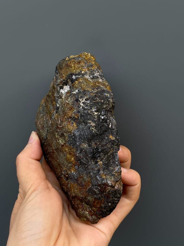 Large iridescent bronze and violet chalcopyrite mass from Hubei, China, detail of the matrix contact