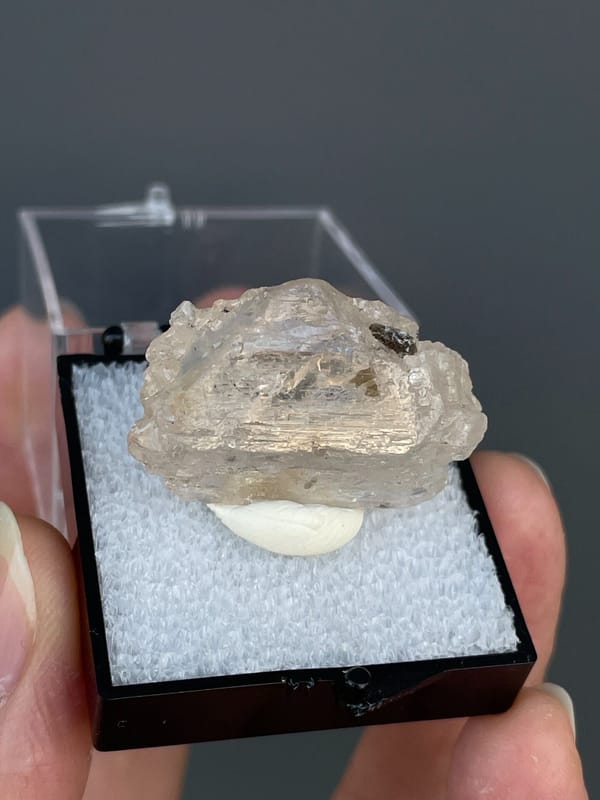 Pale straw topaz crystal in white matrix from Yunnan, China, in a display box