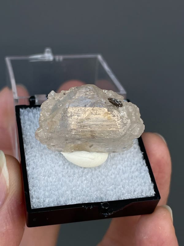 Pale straw topaz crystal in white matrix from Yunnan, China, in a display box, second angle
