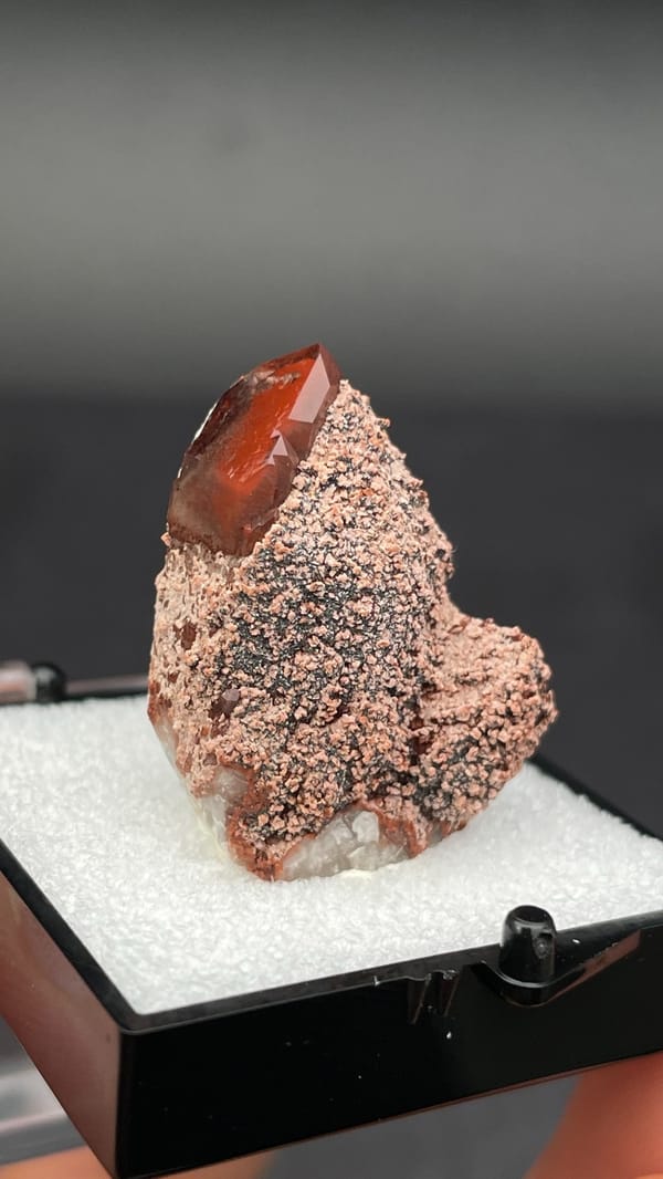 Dusty red hematoid quartz with black specular hematite flecks, Shanxi, China, close-up of the crystal faces
