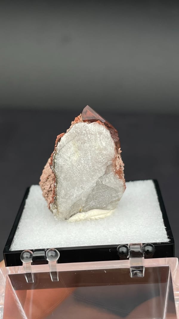 Dusty red hematoid quartz with black specular hematite flecks, Shanxi, China, detail of the matrix contact