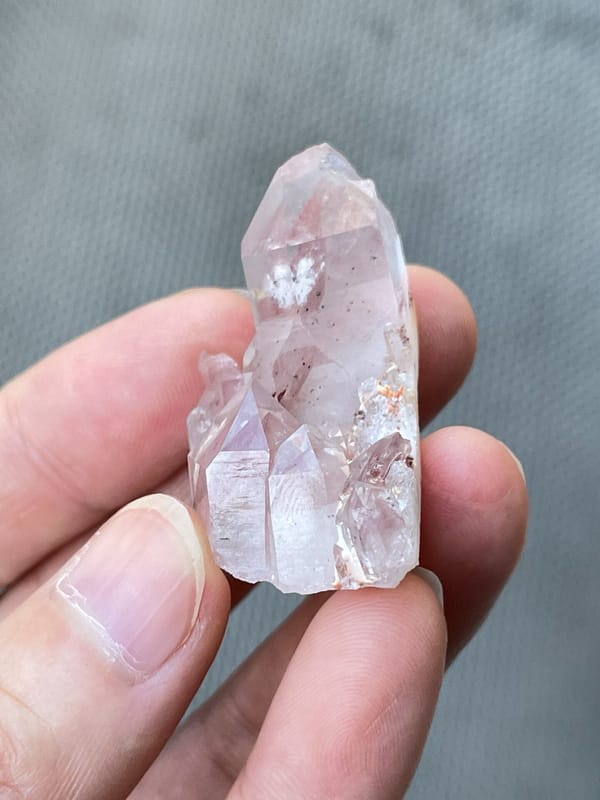 Rose-tinted quartz point group from India, close-up of the crystal faces