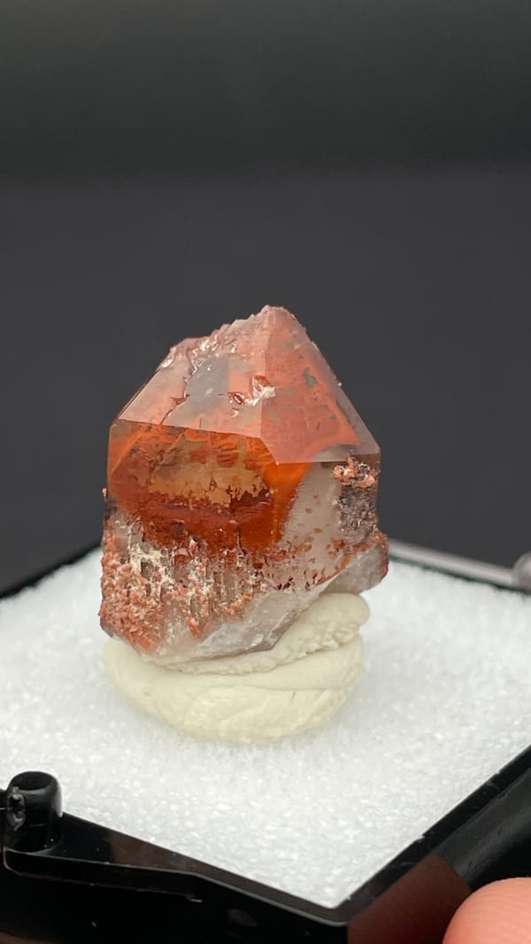 Orange-red hematoid quartz crystal with a clear amber tip from Shanxi, China, close-up of the crystal faces