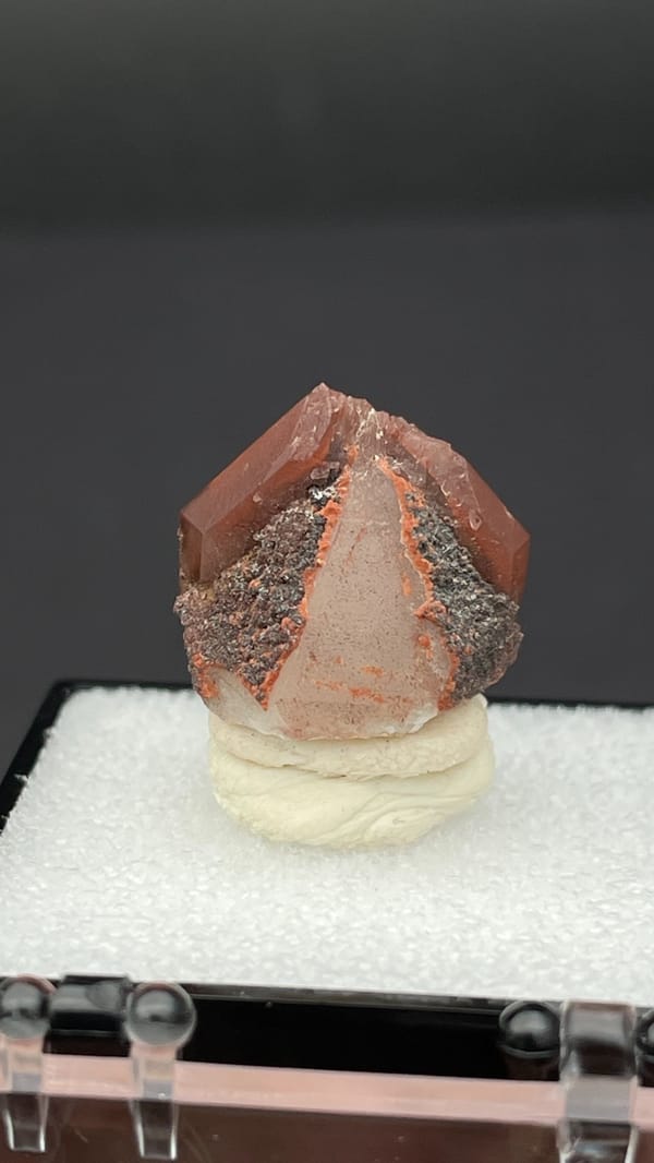 Orange-red hematoid quartz crystal with a clear amber tip from Shanxi, China, top view