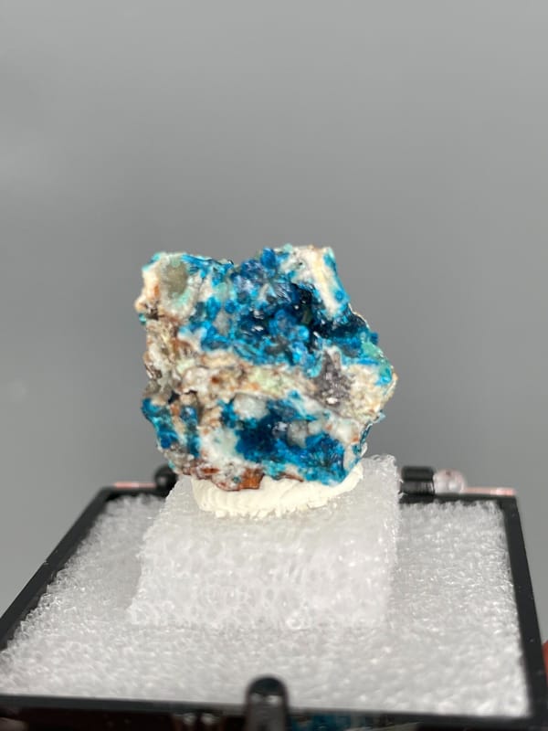 Strong blue veszelyite patches across a pale rock from Yunnan, China