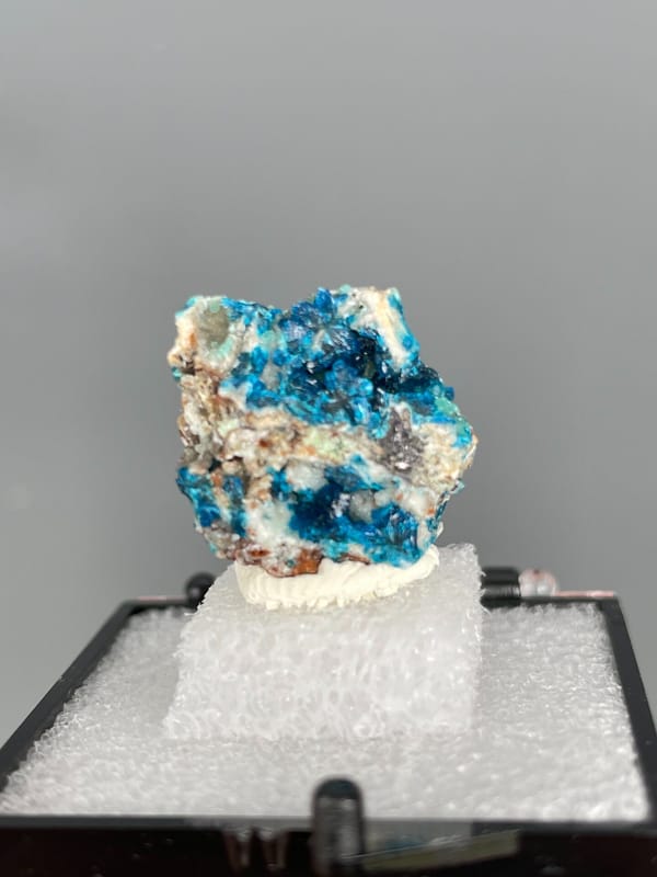 Strong blue veszelyite patches across a pale rock from Yunnan, China, second angle