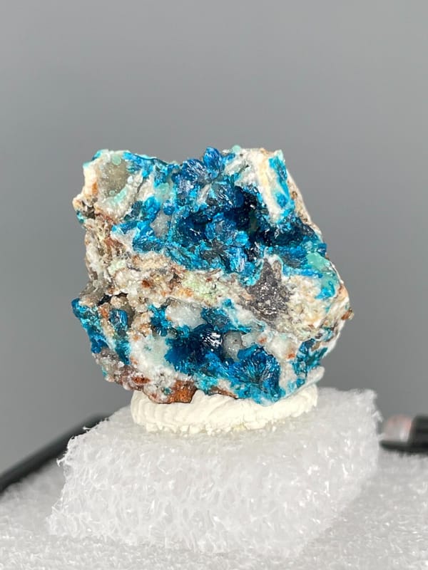 Strong blue veszelyite patches across a pale rock from Yunnan, China, reverse side