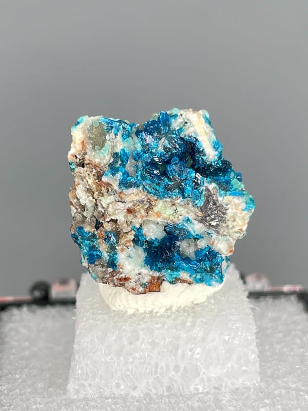 Strong blue veszelyite patches across a pale rock from Yunnan, China, top view