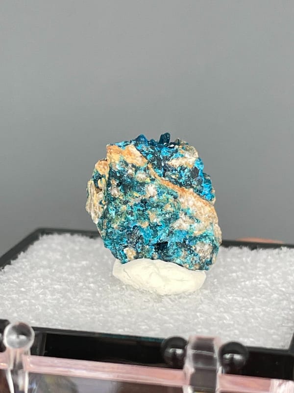 Blue veszelyite divided by a tan rock seam from Yunnan, China, in a box, detail of the matrix contact