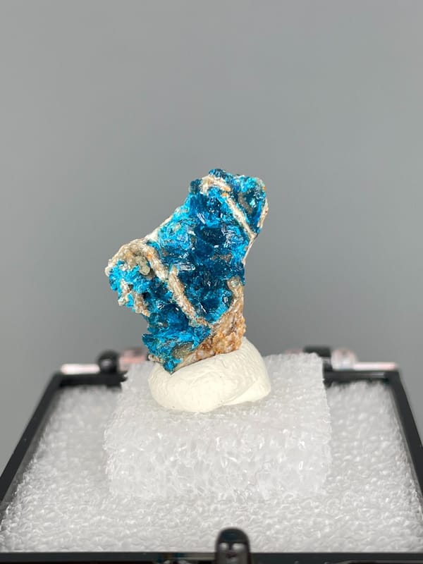 Blue veszelyite crust crossed by a pale vein, Yunnan, China, in a display box, second angle