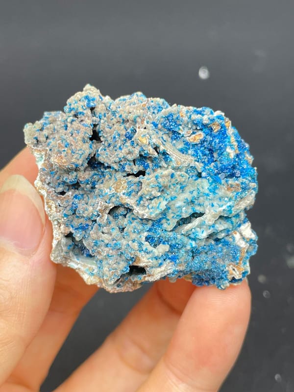 Strong blue veszelyite crust over pale rock from Yunnan, China, detail of the matrix contact