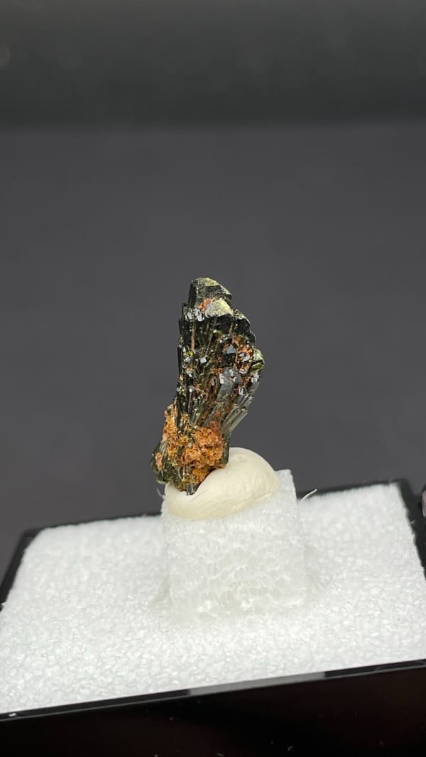 Small fan of olive-green epidote blades on orange base, Handan, Hebei, China, reverse side