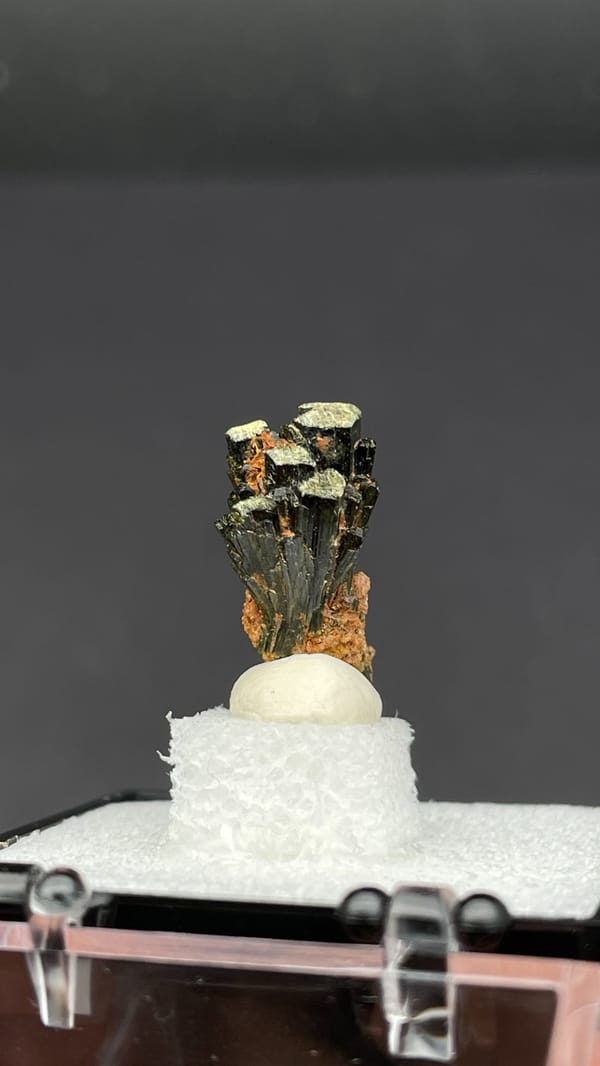 Small fan of olive-green epidote blades on orange base, Handan, Hebei, China, top view