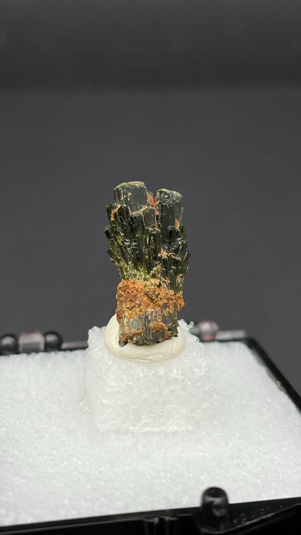 Small fan of olive-green epidote blades on orange base, Handan, Hebei, China, detail of the matrix contact