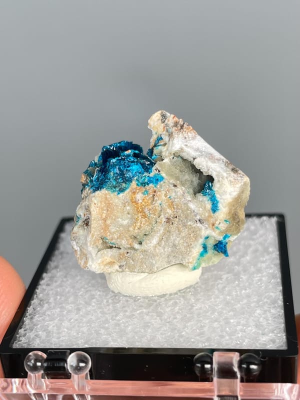 Deep blue veszelyite in the hollows of a pale cream rock, Yunnan, China, reverse side