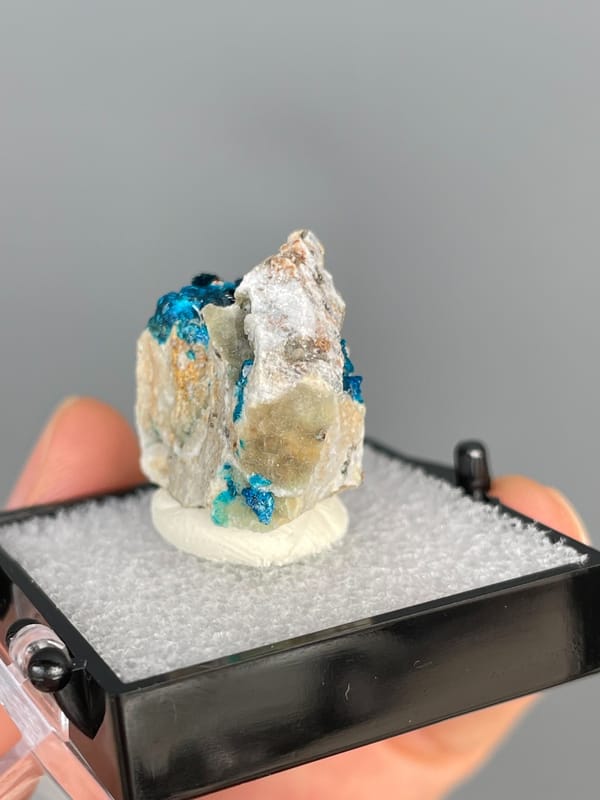 Deep blue veszelyite in the hollows of a pale cream rock, Yunnan, China, top view