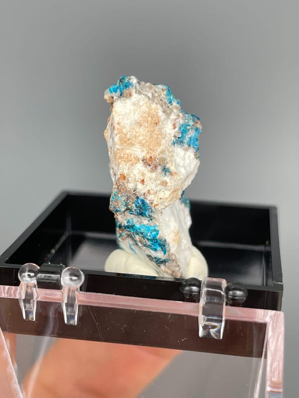 Tall piece with blue veszelyite and orange banding from Yunnan, China, detail of the matrix contact