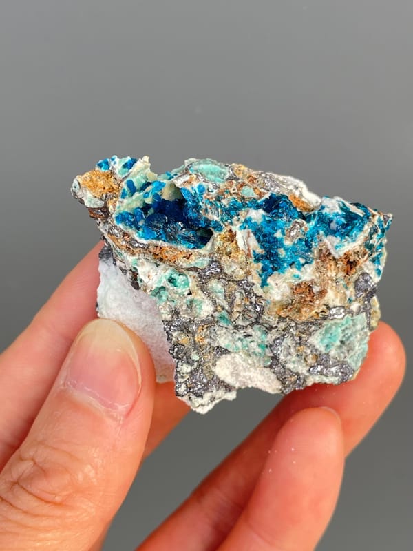 Deep blue veszelyite with turquoise patches on grey rock from Yunnan, China
