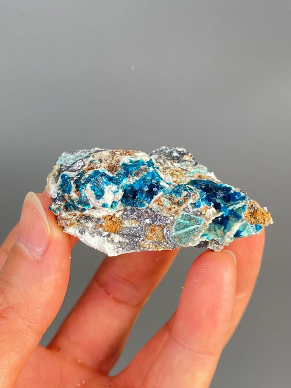 Deep blue veszelyite with turquoise patches on grey rock from Yunnan, China, second angle