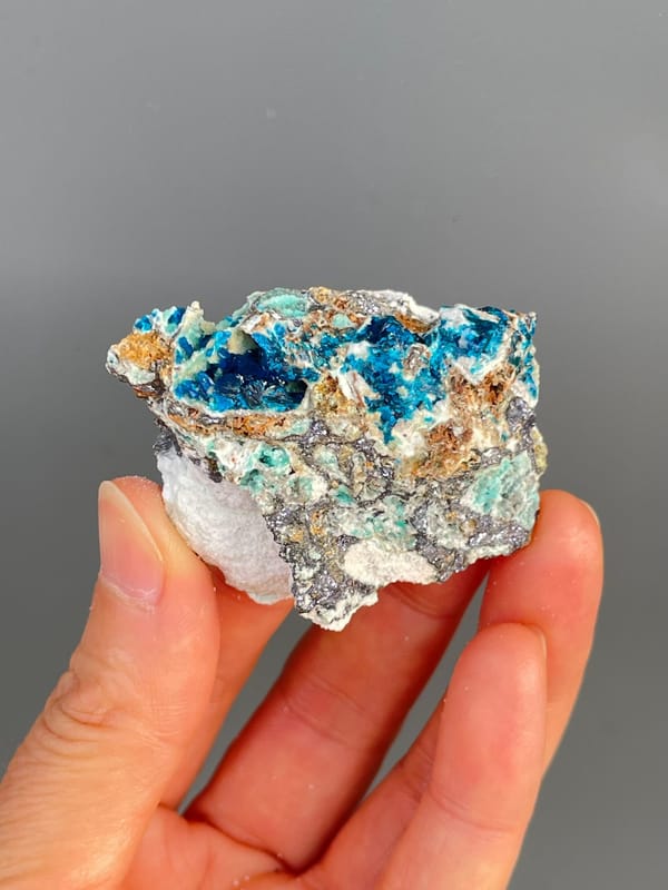 Deep blue veszelyite with turquoise patches on grey rock from Yunnan, China, reverse side