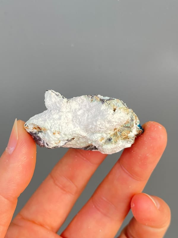 Deep blue veszelyite with turquoise patches on grey rock from Yunnan, China, detail of the matrix contact