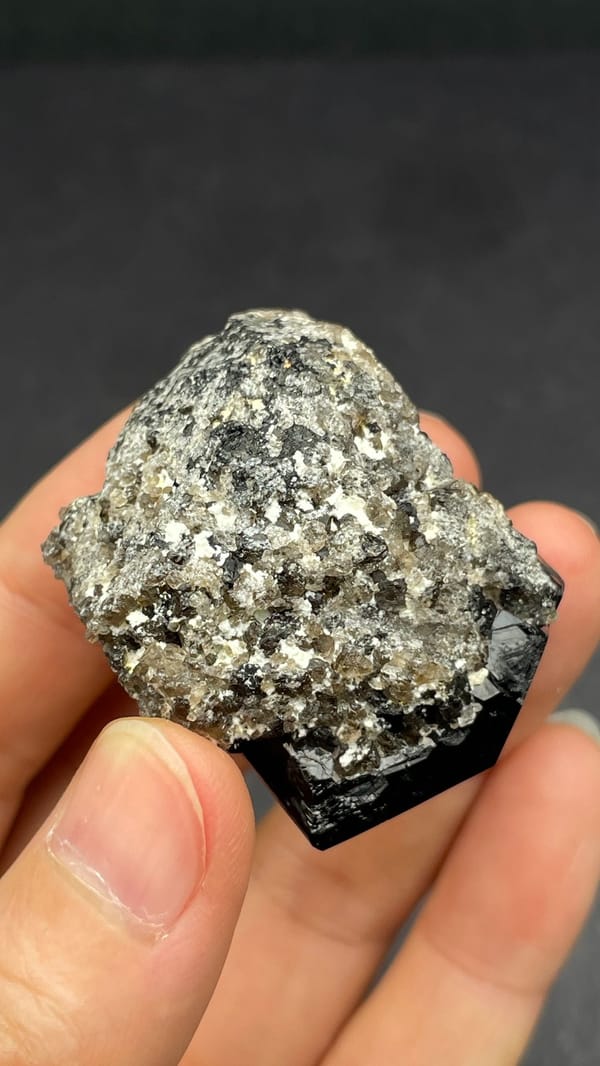 Black schorl tourmaline with three-faced termination on matrix, Namibia, detail of the matrix contact