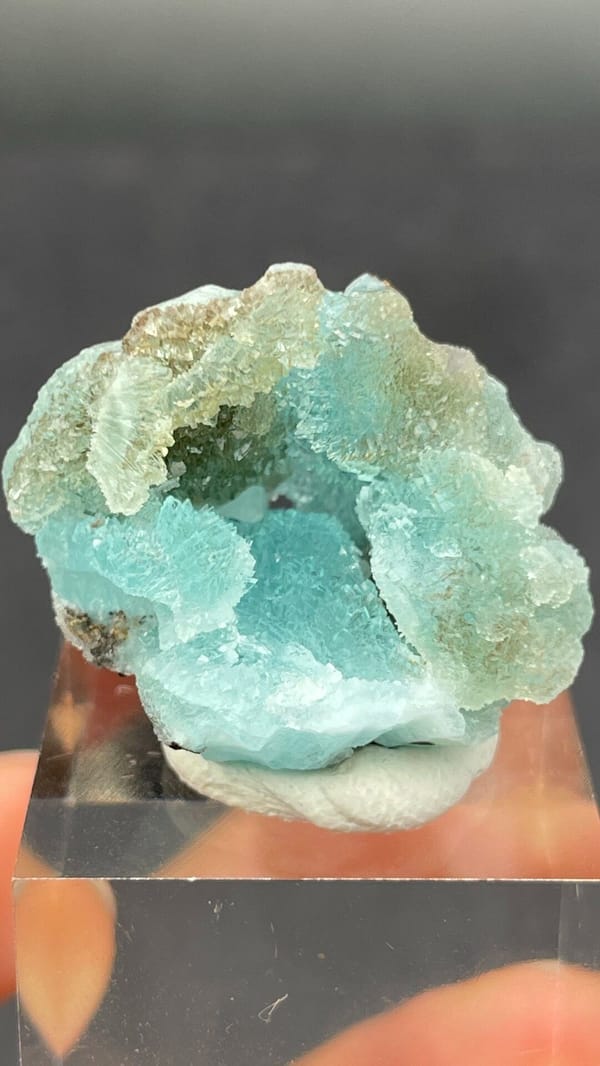 Mint-turquoise botryoidal hemimorphite around a hollow, Guangdong, China, detail of the matrix contact
