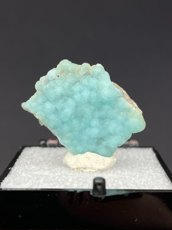 Pale turquoise botryoidal hemimorphite crust from Yunnan, China, in a display box