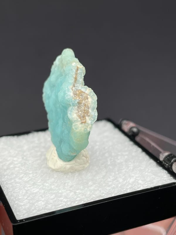 Pale turquoise botryoidal hemimorphite crust from Yunnan, China, in a display box, close-up of the crystal faces