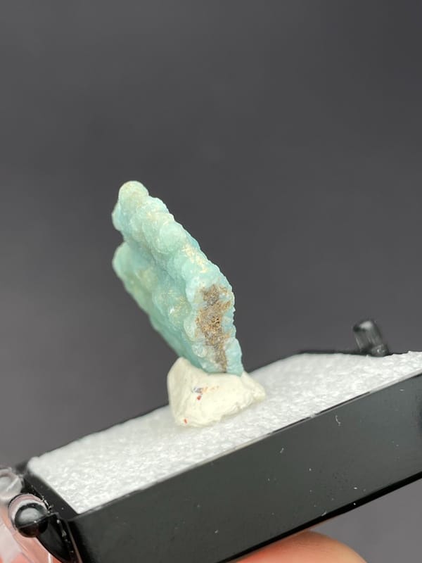 Pale turquoise botryoidal hemimorphite crust from Yunnan, China, in a display box, top view