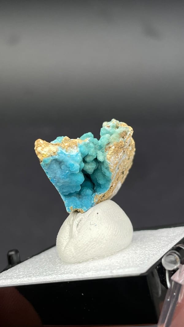 Turquoise botryoidal hemimorphite on tan matrix from Yunnan, China, in a box, top view