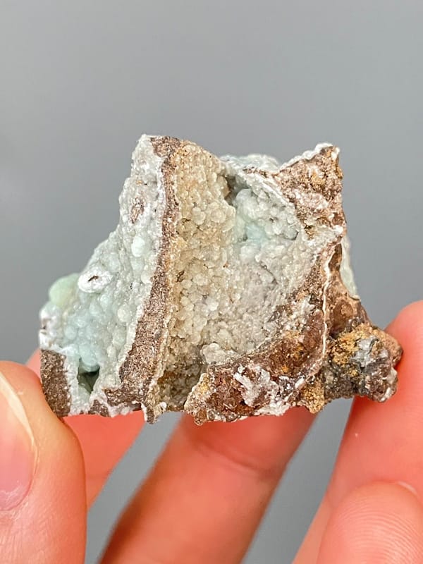 Pale mint-green hemimorphite lining a brown rock cavity from Yunnan, China