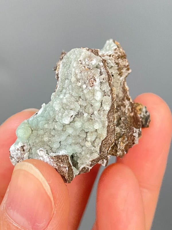 Pale mint-green hemimorphite lining a brown rock cavity from Yunnan, China, second angle