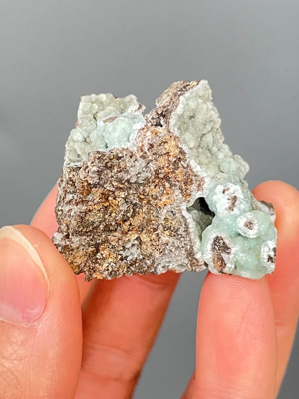 Pale mint-green hemimorphite lining a brown rock cavity from Yunnan, China, reverse side