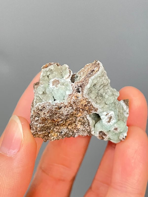 Pale mint-green hemimorphite lining a brown rock cavity from Yunnan, China, top view