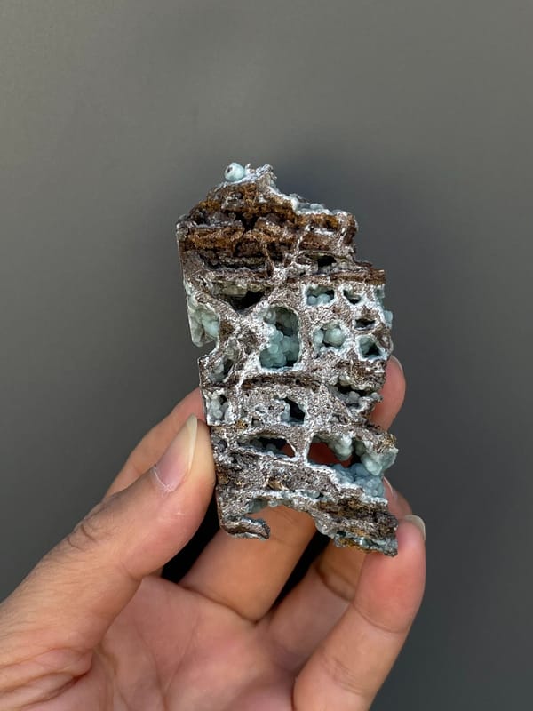 Pale blue-green hemimorphite lining an open skeletal rock, Yunnan, China