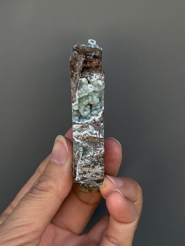 Pale blue-green hemimorphite lining an open skeletal rock, Yunnan, China, reverse side