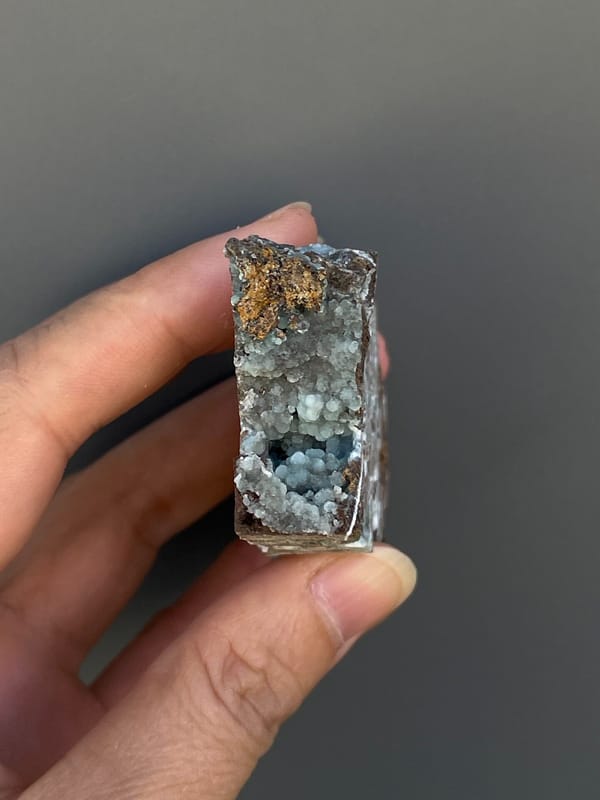 Pale blue-green hemimorphite lining an open skeletal rock, Yunnan, China, detail of the matrix contact